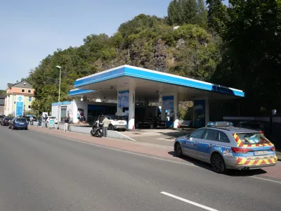 21 September 2021, Rhineland-Palatinate, Idar-Oberstein: A police car is seen parked near a petrol station where a cashier was shot dead apparently over a dispute about wearing a face mask. Photo: Thomas Frey/dpa