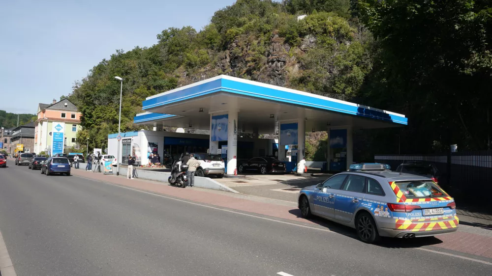 21 September 2021, Rhineland-Palatinate, Idar-Oberstein: A police car is seen parked near a petrol station where a cashier was shot dead apparently over a dispute about wearing a face mask. Photo: Thomas Frey/dpa