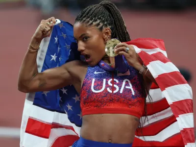 14 September 2025, Japan, Tokyo: USA's Tara Davis-Woodhall poses for a photo with her Gold Medal after winning the Woman's Long Jump Final on Day Two of the World Athletics Championships Tokyo 2025 at National Stadium. Photo: Oliver Weiken/dpa
