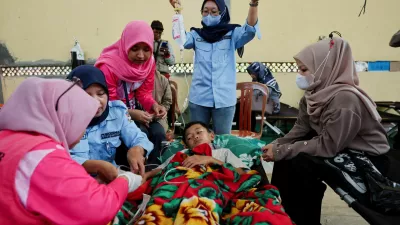FILE PHOTO: Muhammad Setiawan Pratama, 11, an elementary student receives treatment for food poisoning after eating government-sponsored free school meals, at a makeshift clinic inside a district's hall in Bandung, West Java province, Indonesia, September 25, 2025. REUTERS/Willy Kurniawan/File Photo