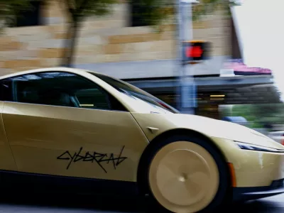 A gold-colored Tesla Cybercab arrives for an event in downtown Austin, Texas, U.S., September 3, 2026. Picture taken with a slow shutter speed. REUTERS/Kaylee Greenlee