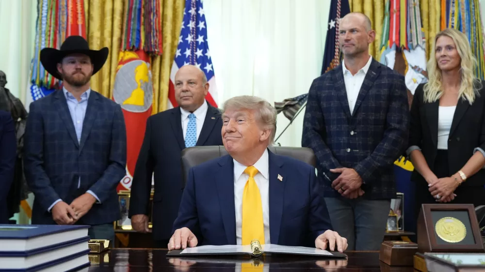 President Donald Trump speaks and announces action to help farmers and ranchers, as a group of farmers and ranchers stand behind, Friday, Sept. 4, 2026, in the Oval Office of the White House, in Washington. (AP Photo/Jacquelyn Martin)