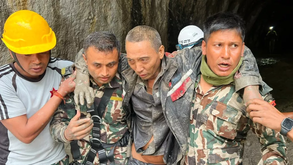 In this photo provided by the Nepal Army, a Chinese national is seen after being rescued by soldiers during an ongoing operation at the Trishuli-3A hydropower project in Nepal's Rasuwa district, Saturday, Sept. 5, 2026. (Nepal Army via AP)
