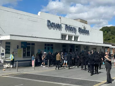 Protesters gather at Dover Priory train station after black-clad and masked demonstrators blocked roads during a protest, in Dover, England, Saturday, Sept. 5, 2026. (Oscar Rihll/PA via AP)