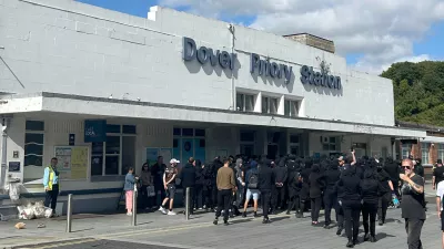 Protesters gather at Dover Priory train station after black-clad and masked demonstrators blocked roads during a protest, in Dover, England, Saturday, Sept. 5, 2026. (Oscar Rihll/PA via AP)