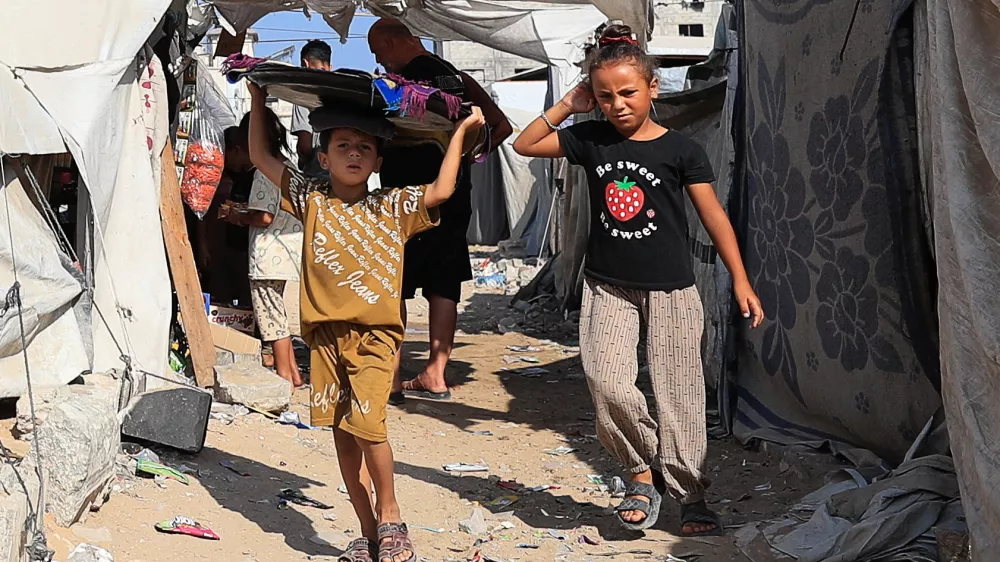 Palestinian children walk at a tent camp sheltering displaced people, in Gaza City, September 4, 2026. REUTERS/Dawoud Abu Alkas