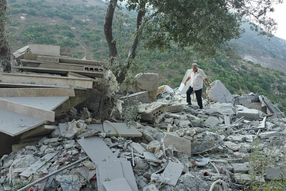 A man makes way through rubble at the site of an Israeli strike, in Arab Salim, Lebanon, September 6, 2026. Picture taken with a mobile phone. REUTERS/Ali Hankir