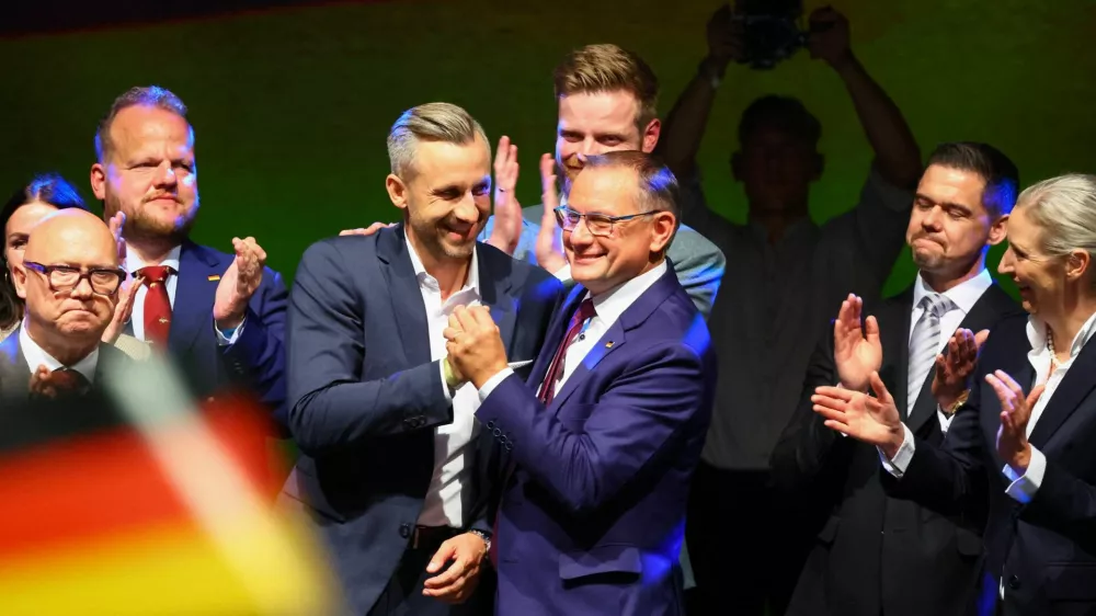 Top candidate of the far-right Alternative for Germany (AfD) Ulrich Siegmund greets Tino Chrupalla onstage at the AfD election party after polls closed in the Saxony-Anhalt state elections and exit polls were announced, in Magdeburg, Germany, September 6, 2026. REUTERS/Fabrizio Bensch