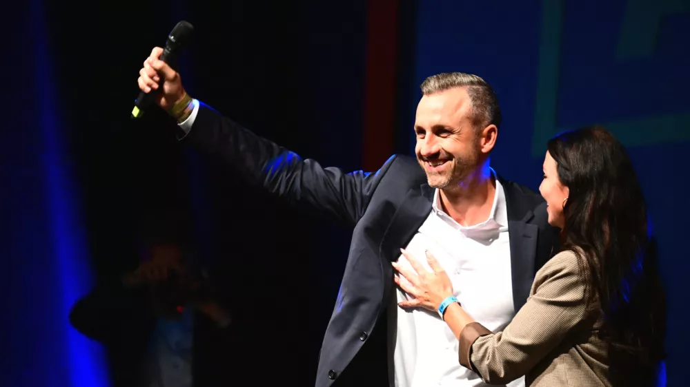 Ulrich Siegmund, left, (AfD), the party's top candidate and co-chair of the AfD state parliamentary group in Saxony-Anhalt, and his wife Julia Siegmund stand on stage at the AfD's election party in Magdeburg, Germany, Sunday, Sept. 6, 2026. (Michael Kappeler/dpa via AP)