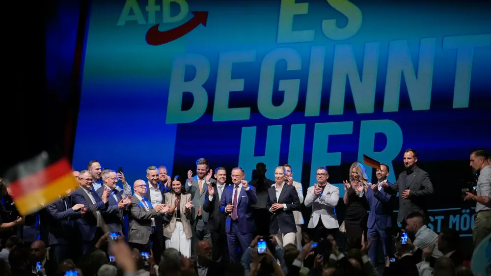 Top candidate Ulrich Siegmund and party leaders Tino Chrupalla and Alice Weidel, speak to party members in front of a reading "it starts here" at an election party of the "Alternative for Germany" (AfD) after the Saxony-Anhalt state elections in Magdeburg, eastern Germany, Sunday, Sept. 6, 2026. (AP Photo/Matthias Schrader)