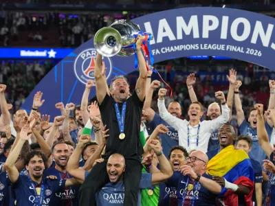 PSG's head coach Luis Enrique celebrates with the trophy after defeating Arsenal during the Champions League final soccer match between Paris Saint-Germain and Arsenal in Budapest, Hungary, Saturday, May 30, 2026. (AP Photo/Andreea Alexandru)