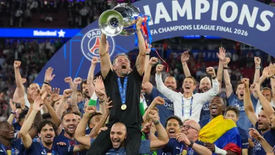 PSG's head coach Luis Enrique celebrates with the trophy after defeating Arsenal during the Champions League final soccer match between Paris Saint-Germain and Arsenal in Budapest, Hungary, Saturday, May 30, 2026. (AP Photo/Andreea Alexandru)