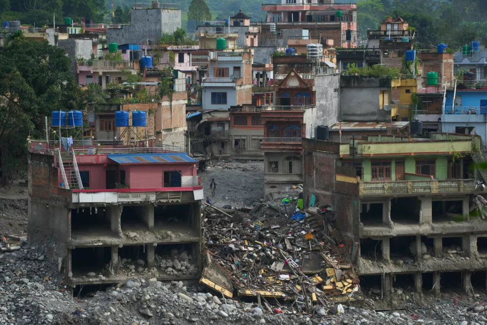 Houses damaged by flash flood are seen on the bank of Trishuli river in Dhunge, Nuwakot district, Nepal, Monday, Sept. 7, 2026. (AP Photo/Niranjan Shrestha)