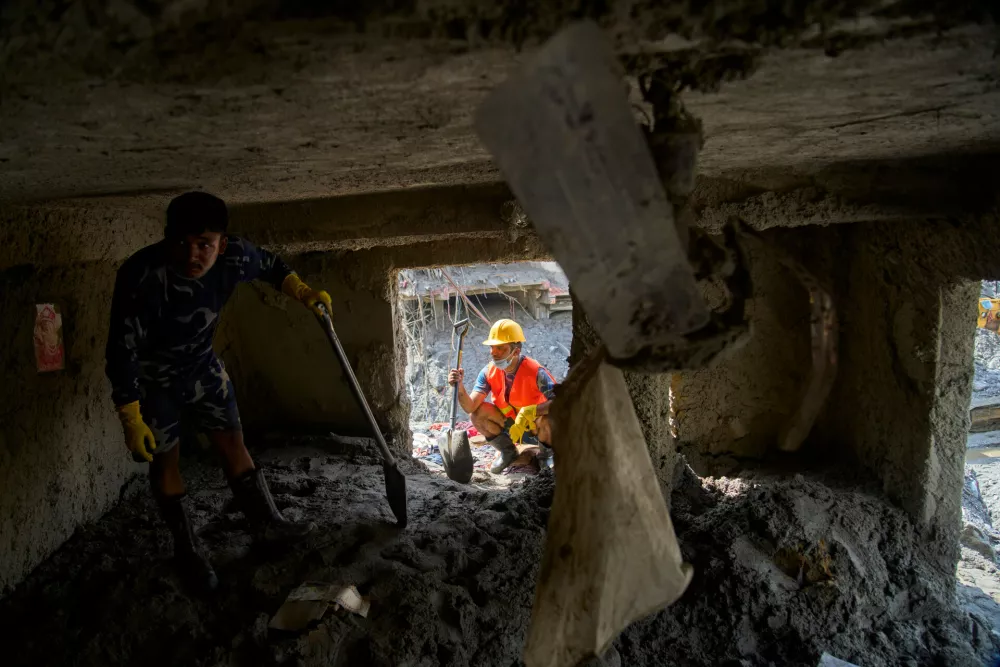 Nepalese Armed Police Force personnel check for signs of survivors inside a house damaged by flash floods in Dhunge, Nuwakot district, Nepal, Monday, Sept. 7, 2026. (AP Photo/Niranjan Shrestha)