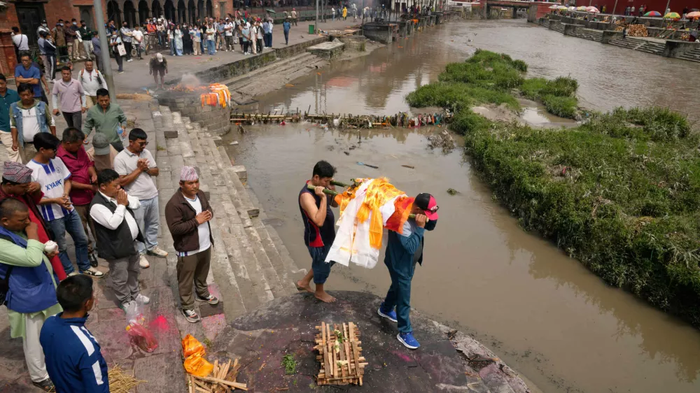 Relatives carry an effigy of a loved one missing in the recent flash floods during a symbolic funeral on the banks of the Bagmati River in Kathmandu, Nepal, Monday, Sept. 7, 2026. (AP Photo/Dar Yasin)