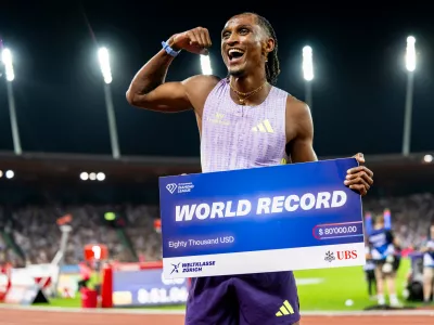Brazil's Alison dos Santos celebrates winning the men's 400-meter hurdles, setting a new world record, at the Diamond League athletics meeting, Thursday, Aug. 27, 2026, in Zurich, Switzerland. (Jean-Christophe Bott/Keystone via AP)