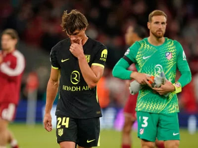 Atletico Madrid's Robin Le Normand and Atletico Madrid's goalkeeper Jan Oblak leave the pitch after losing the Champions League opening phase soccer match between Liverpool and Atletico Madrid in Liverpool, England, Wednesday, Sept. 9, 2026. (AP Photo/Dave Thompson)