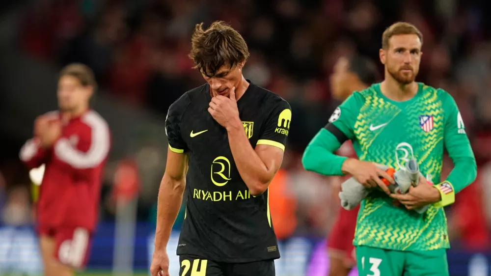 Atletico Madrid's Robin Le Normand and Atletico Madrid's goalkeeper Jan Oblak leave the pitch after losing the Champions League opening phase soccer match between Liverpool and Atletico Madrid in Liverpool, England, Wednesday, Sept. 9, 2026. (AP Photo/Dave Thompson)