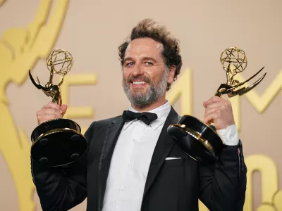 Matthew Rhys poses in the press room with the awards for outstanding lead actor in a limited or anthology series or movie for "The Beast In Me," and outstanding lead actor in a comedy series for "Widow's Bay" during the 78th Emmy Awards on Monday, Sept. 14, 2026, at the JW Marriott in Los Angeles. (Photo by Richard Shotwell/Invision/AP)