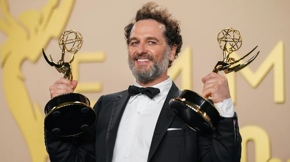 Matthew Rhys poses in the press room with the awards for outstanding lead actor in a limited or anthology series or movie for "The Beast In Me," and outstanding lead actor in a comedy series for "Widow's Bay" during the 78th Emmy Awards on Monday, Sept. 14, 2026, at the JW Marriott in Los Angeles. (Photo by Richard Shotwell/Invision/AP)