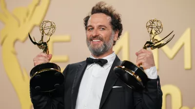 Matthew Rhys poses in the press room with the awards for outstanding lead actor in a limited or anthology series or movie for "The Beast In Me," and outstanding lead actor in a comedy series for "Widow's Bay" during the 78th Emmy Awards on Monday, Sept. 14, 2026, at the JW Marriott in Los Angeles. (Photo by Richard Shotwell/Invision/AP)