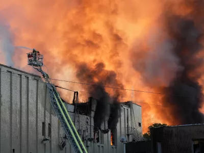Firefighters put out a fire during Russian massive air attack in Kyiv, Ukraine Tuesday, Sept. 8, 2026. (AP Photo/Efrem Lukatsky)