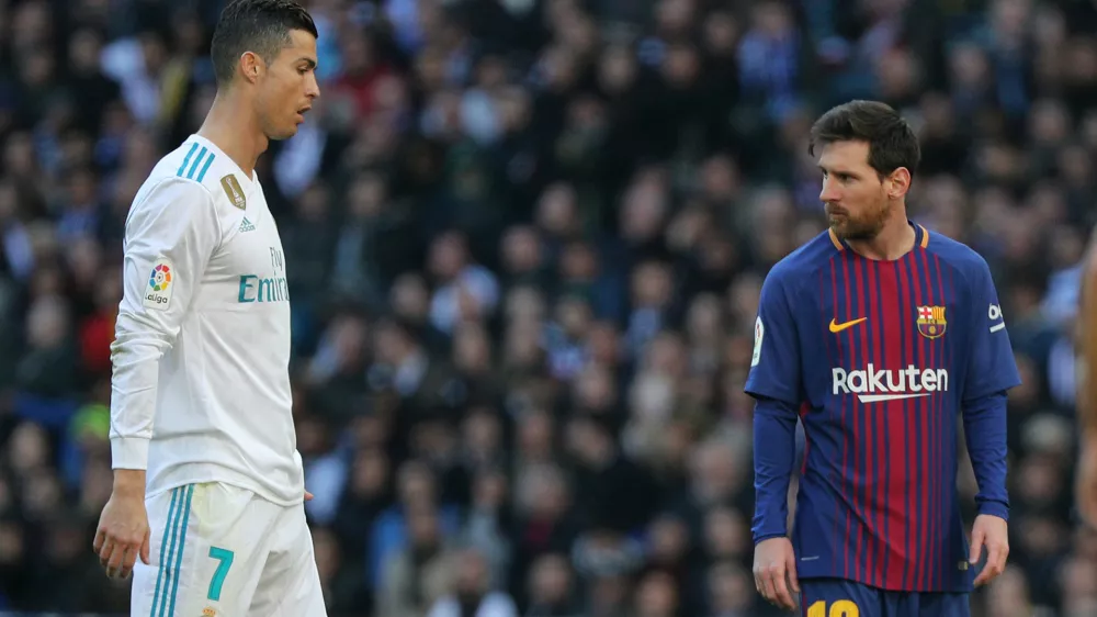 Soccer Football - La Liga Santander - Real Madrid vs FC Barcelona - Santiago Bernabeu, Madrid, Spain - December 23, 2017  Barcelona's Lionel Messi alongside Real Madrid's Cristiano Ronaldo  REUTERS/Sergio Perez - RC142B11CE60