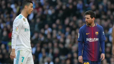 Soccer Football - La Liga Santander - Real Madrid vs FC Barcelona - Santiago Bernabeu, Madrid, Spain - December 23, 2017  Barcelona's Lionel Messi alongside Real Madrid's Cristiano Ronaldo  REUTERS/Sergio Perez - RC142B11CE60