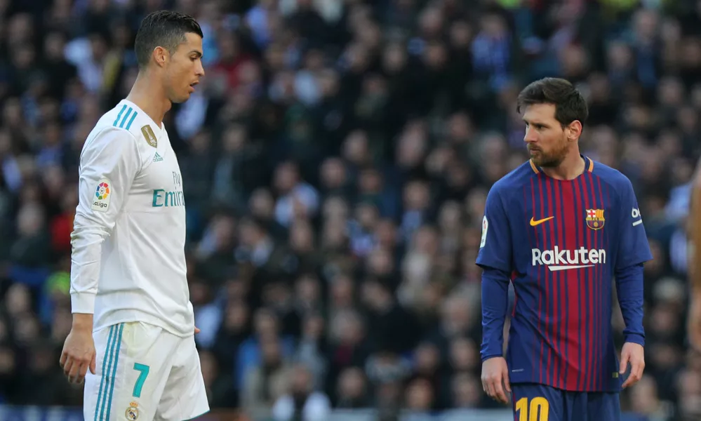 Soccer Football - La Liga Santander - Real Madrid vs FC Barcelona - Santiago Bernabeu, Madrid, Spain - December 23, 2017  Barcelona's Lionel Messi alongside Real Madrid's Cristiano Ronaldo  REUTERS/Sergio Perez - RC142B11CE60