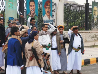 Houthi supporters pose a groom in front of posters from right showing late Hamas leader Ismail Haniyeh, and what they describe martyrs Maher Al-Jazi of Jordan, Mohammed Salah of Egypt, in Sanaa, Yemen, Sunday, Sept. 6, 2026. (AP Photo/Osamah Abdulrahman)