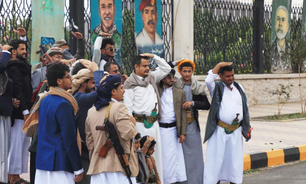 Houthi supporters pose a groom in front of posters from right showing late Hamas leader Ismail Haniyeh, and what they describe martyrs Maher Al-Jazi of Jordan, Mohammed Salah of Egypt, in Sanaa, Yemen, Sunday, Sept. 6, 2026. (AP Photo/Osamah Abdulrahman)