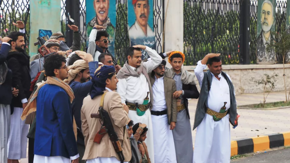 Houthi supporters pose a groom in front of posters from right showing late Hamas leader Ismail Haniyeh, and what they describe martyrs Maher Al-Jazi of Jordan, Mohammed Salah of Egypt, in Sanaa, Yemen, Sunday, Sept. 6, 2026. (AP Photo/Osamah Abdulrahman)