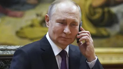 Russian President Vladimir Putin talks on the phone to eight-year-old Alexandra Titarenko from Zaporizhzhia region, a participant in the Fir Tree of Wishes charity campaign at the State Russian Museum in St. Petersburg, Russia, Tuesday, Dec. 27, 2022. (Alexey Danichev, Sputnik, Kremlin Pool Photo via AP)
