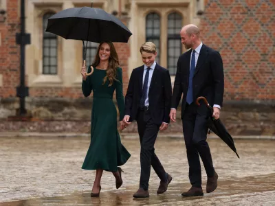 Britain's Kate, Princess of Wales, left, and Britain's Prince William walk with their 13-year-old son, Britain's Prince George, as he arrives for his first day at Eton College, in Eton, west of London, Tuesday, Sept. 8, 2026. (Adrian Dennis/Pool Photo via AP)