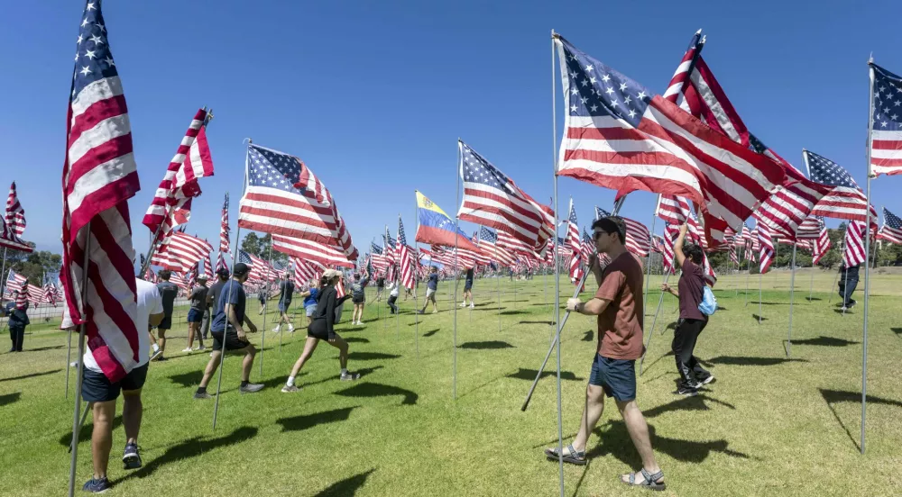 September 05, 2026 - Malibu, California, USA: Hundreds of volunteers gather at Alumni Park at Pepperdine University to raise nearly 3,000 flags in honor of the lives lost to the terrorist attack on the United States on September 11, 2001. The flags also include national flags for each foreign country that lost a citizen in the attack. The Waves of Flags memorial will remain in place along Pacific Coast Highway until September 18, 2026.(Credit Image: &copy; Brian Cahn/ZUMA Press Wire)