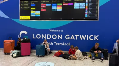 Passengers at Gatwick Airport's South Terminal sit after flights were cancelled because of a technical issue in Britain's air traffic control system Tuesday, Sept. 8, 2026, in Crawley, south of London. (Jordan Pettitt/PA via AP)