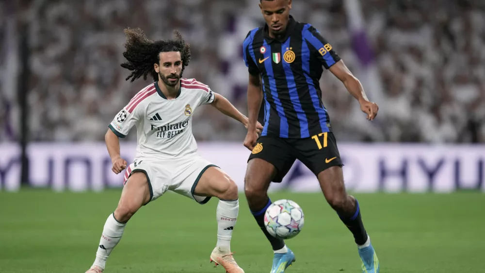 Real Madrid's Marc Cucurella fights for the ball against Inter Milan's Andy Diouf during a Champions League soccer match between Real Madrid and Inter Milan in Madrid, Spain, Tuesday, Sept. 8, 2026. (AP Photo/Bernat Armangue)