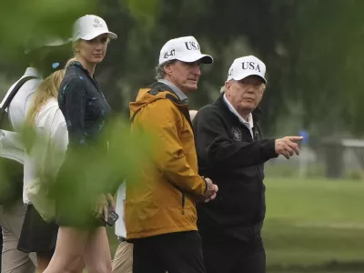 President Donald Trump, from right, Interior Secretary Doug Burgum and White House aide Natalie Harp tour the East Potomac Park golf course, Sunday, June 28, 2026, in Washington. (AP Photo/Mark Schiefelbein)