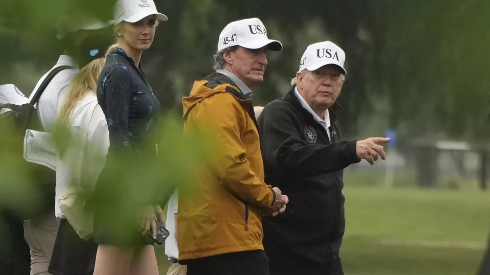 President Donald Trump, from right, Interior Secretary Doug Burgum and White House aide Natalie Harp tour the East Potomac Park golf course, Sunday, June 28, 2026, in Washington. (AP Photo/Mark Schiefelbein)