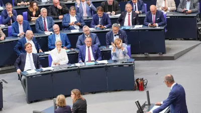 Federal chairwoman and parliamentary group leader of the AfD Alice Weidel, sitting in first row, centre left, looks at German Chancellor Friedrich Merz as he speaks during the general debate as part of the budget deliberations in the Bundestag, in Berlin, Wednesday Sept. 9, 2026. (Michael Kappeler/dpa via AP)