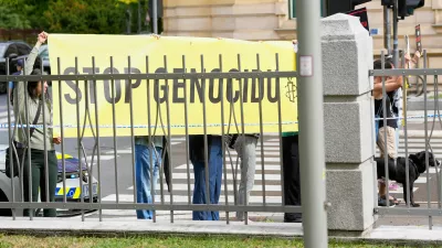 A group of protesters hold a banner outside the Slovenian foreign ministry during a visit of Israel's Foreign Minister Gideon Sa'ar, in Ljubljana, Slovenia, Wednesday, Sept. 9, 2026. (AP Photo/Darko Bandic)