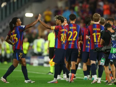 Soccer Football - UEFA Champions League - FC Barcelona v Feyenoord - Spotify Camp Nou, Barcelona, Spain - September 9, 2026 FC Barcelona's Lamine Yamal celebrates scoring their fourth goal with Jules Kounde REUTERS/Albert Gea