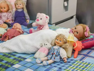 Story from Jam Press (Lives 100 Dolls) Pictured: Some of the dolls from Marie's growing collection.'I live with 100 dolls and talk to them &ndash; I don't care if people think I'm crazy, they're my babies'A woman who lives with 100 dolls and admits to speaking to them says she doesn't care if people think she is crazy.Marie Odendaal started playing with dolls as a way to communicate with her daughter, who has cerebral palsy &ndash; a brain disorder that appears in infancy or early childhood and permanently affects body movement, muscle coordination and can disrupt speech.But now, the 69-year-old has built up a collection of 100 dolls and a thriving business making 400 tiny outfits a week for fellow doll-lovers.And they aren't just toys to her &ndash; but her "babies"."I do talk to my dolls," Marie told What's The Jam."I say good morning to Samantha, but she remains silent - which is expected considering she's a doll."My dolls are my life &ndash; and that's why I talk to them."People can think I'm crazy but I don't care."Marie says she's known as the doll lady because dolls are her passion &ndash; and making outfits for her "babies" and for other doll lovers is her life's work.She said: "I've put some on display before too."Some in elegant evening gowns, a wedding dress, swimming costumes and cheerful summer frocks."And a Ken doll wearing camouflage trousers."He's turned away from the girls next to him."Maybe it's the delicate items of underwear I create that have made him coy."People ask why I make underwear for dolls and I say, 'Don't you teach your children to always wear underwear?'."Marie is proud of her work.Every design, every piece of thread, every little flower or bead is selected with care and the stitching is done painstakingly by hand or on her sewing machine.She said: "I can't stand shoddy work."This is my full-time job, after all."But it's about more than just income."It was the one thing both her and her daughter Jolanda, now 50, really loved when she was a child.She said: "We played with them together."Samantha is Jolanda's doll."Jolanda lives in a care home but sleeps on the bed in the kitchen when she comes home for holidays."And the money from selling doll clothes helps pay for Jolanda's care.Marie, from Kempton Park, South Africa, said: "I make about 30 outfits a day &ndash; that's about 400 items a week."As I work I also talk to my dolls."Samantha is Jolanda's baby but she stays with me because she needs to be looked after."And for me, she's a piece of Jolanda I can still have every day."Her unique home enterprise allows her to combine her two big loves &ndash; dolls and making clothes.Decades ago, after divorcing her first husband, the mum-of-three did a needlework course and started making and selling every-thing from wedding dresses to daywear in order to supplement her income as an office worker.She also made little outfits for her own dolls purely as a hobby.Between the dressmaking, she cared for Jolanda, who has never been able to walk.She said: "I carried her from one place in the house to another."But 10 years ago my body started giving in."I've had five back operations and two hip replacements and Jolanda had to go to a care facility because I could no longer manage her alone."But even after that Marie was determined to keep working.She said: "I'm not one for pottering about, reading or watching TV."Needlework is what I do."And anyway, I still have to somehow pay for my daughter's necessities."Marie's second husband, Rudi, 66, is often away from home due to his work as a fitter and turner on the mines.He built her worktable and helped set up her "production line" &ndash; her sewing machines, plastic containers full of materials and accessories, tiny dress patterns laid out, fabrics, scissors, spools of thread and containers with pins.She said: "It's colourful chaos that fills every corner, but everything is exactly the way I want it."I switched to making doll clothes because it's easier than making outfits for people."You can also cut and stitch more clothes from one roll of fabric."And I love what I do."She has five big clients she supplies doll clothes to wholesale, and they sell them in shops across the country.She said: "Then there are also people who drive from as far as Kimberley to buy things for their children."I'm not expensive be cause I want every child to have little clothes for their dolls."They go as far away as South Africa, Australia and Europe."And her husband doesn't mind.He has his own passion &ndash; his classic Ford Cortina, which he works on when he's home.She said: "I always tell him his hobby costs us money, but mine actually makes money."I still love playing with dolls &ndash; it's what my daughter and I have always done."I also had a friend who would come over and play with me and we held everything from doll tea parties to weddings over the years."The dolls still come out of their boxes sometimes."ENDS,Image: 1055112948, License: Rights-managed, Restrictions:, Model Release: no 