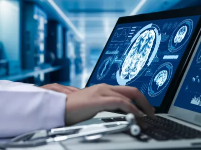 Close up of doctor working on tablet and laptop with human brain anatomy display on screen. Smart medical worker checking hand and diagnosis brain injury while preparing for brain surgery. Remedial.