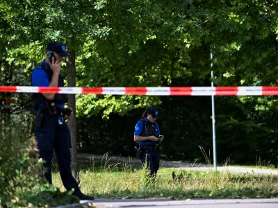 Police stand next to barricade tape near the site of a deadly shooting at a rave party, according to the police, at Schachen in Aarau, Switzerland, August 30, 2026. REUTERS/Romina Amato   TPX IMAGES OF THE DAY