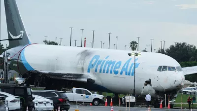 Workers inspect an Amazon cargo plane that overshot a runway four days ago at Miami International Airport, Thursday, Sept. 10, 2026, in Miami. (AP Photo/Marta Lavandier)