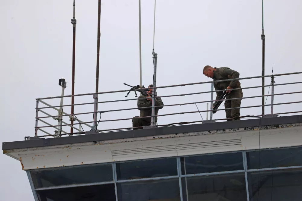 Snipers take up position on an air traffic control tower ahead of the arrival of U.S. President Donald Trump, at Shannon Airport, as Trump travels to the Irish Open at the Trump International Golf Links & Hotel, in Doonbeg, Ireland, Saturday, Sept. 12, 2026.(Liam McBurney/PA via AP)