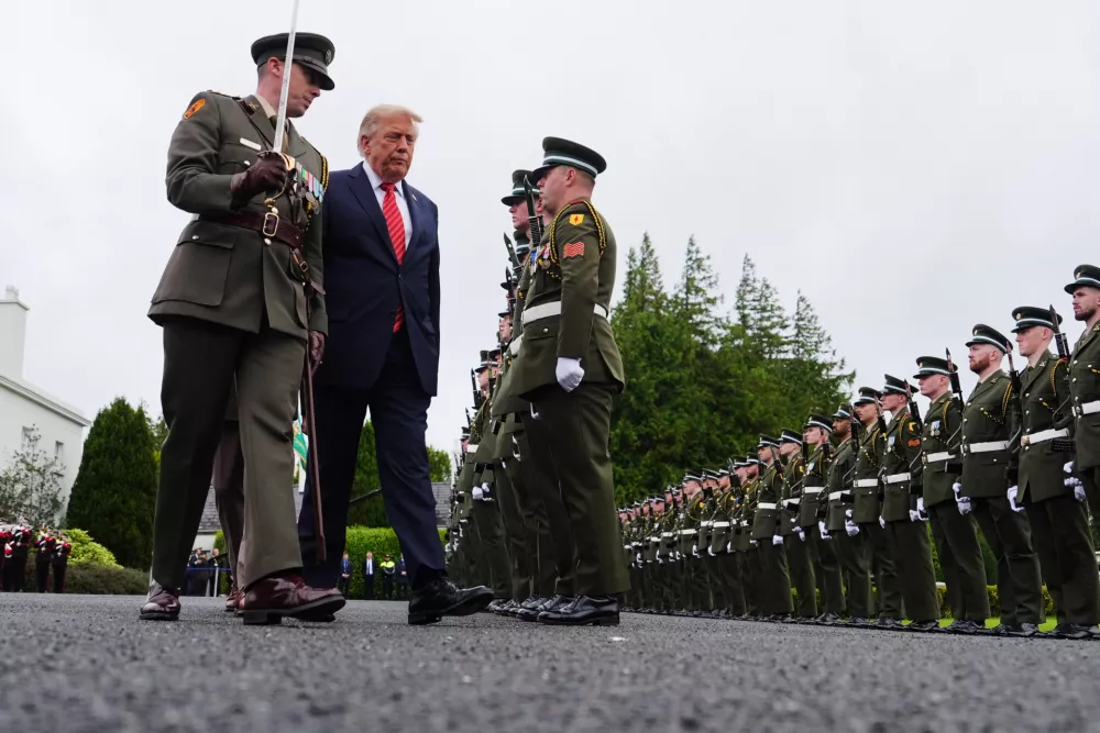 U.S. President Donald Trump, center, during a review of soldiers from the Guard of Honor during a visit with Ireland's President Catherine Connolly at &Aacute;ras an Uachtar&aacute;in in Dublin, Saturday, Sept. 12, 2026. (AP Photo/Julia Demaree Nikhinson)