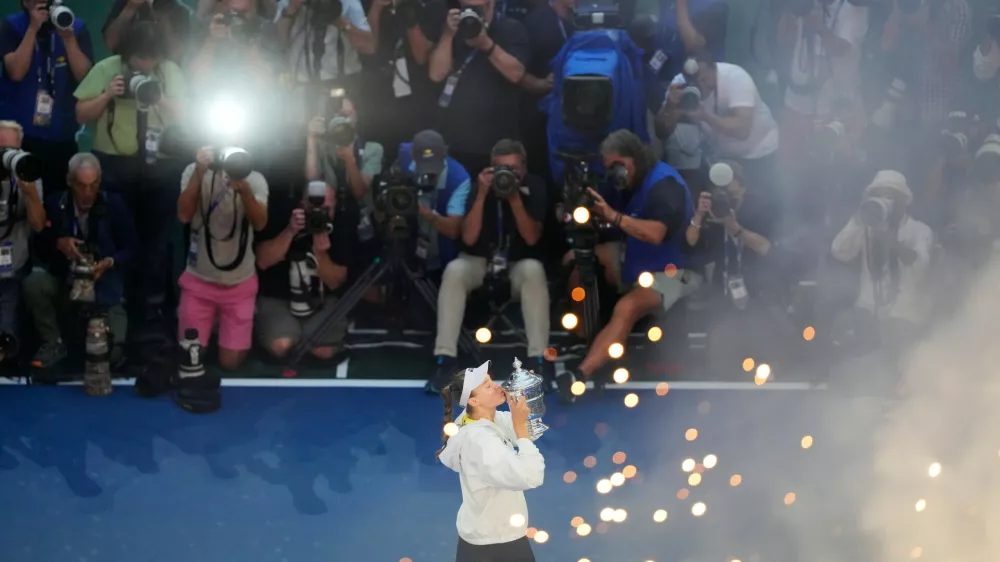 Elena Rybakina, of Kazakhstan, kisses the trophy after she won the women's singles final of the U.S. Open tennis championships against Aryna Sabalenka, of Belarus, Saturday, Sept. 12, 2026, in New York. (AP Photo/Yuki Iwamura)
