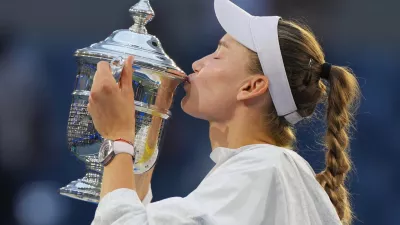 Elena Rybakina, of Kazakhstan, kisses the trophy after she won the women's singles final of the U.S. Open tennis championships against Aryna Sabalenka, of Belarus, Saturday, Sept. 12, 2026, in New York. (AP Photo/Kirsty Wigglesworth)